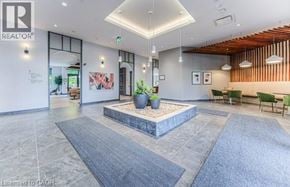 Kitchener condo for rent - A modern office lobby with a reception desk and seating area.