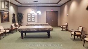 Brampton (Sandringham-Wellington) condo for rent - A bedroom with a bed, chairs, and a painting on the wall.