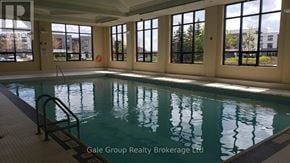 Brampton (Sandringham-Wellington) condo for rent - A large indoor swimming pool with a ladder on the side.