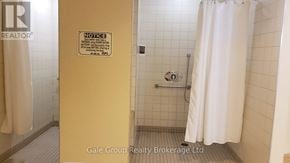 Brampton (Sandringham-Wellington) condo for rent - A bathroom with a shower curtain and a sign on the door.