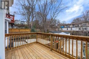 Toronto (Blake-Jones) townhouse for rent - A wooden deck with a railing and a view of a residential area.