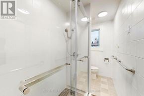 Toronto (Blake-Jones) townhouse for rent - A white bathroom with a walk-in shower and a toilet.
