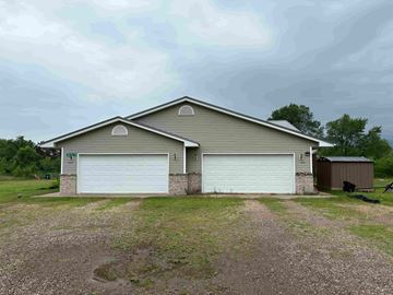 Elk Mound apartment for rent - A two-car garage is attached to a house.