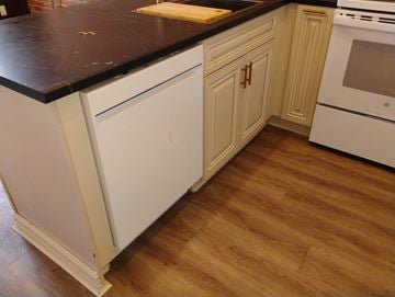 Belleville apartment for rent - A kitchen with white cabinets and a black countertop.