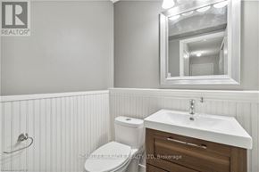 Burlington (Orchard) apartment for rent - A white bathroom with a toilet, sink and mirror.