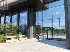 Mississauga (Port Credit) condo for rent - The image shows the front of a building with the sign "251 Masonry Way" on the glass doors.