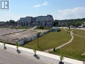 Mississauga (Port Credit) condo for rent - A large building with a grassy area in front of it.