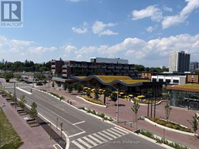 Mississauga (Port Credit) condo for rent - A city street with a building that has a green roof.