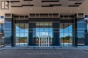 Burlington (Freeman) condo for rent - The image shows the front of a building with a glass entrance and a sign that reads "REALTOR".