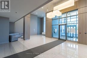 Burlington (Freeman) condo for rent - A spacious office lobby with a bench, a reception desk, and a large window.