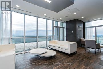 Burlington (Freeman) condo for rent - A living room with a couch, chair, and coffee table with a view of the ocean.
