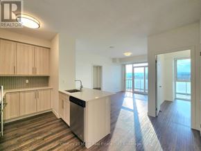 Burlington (Freeman) condo for rent - A kitchen with wooden cabinets and a white countertop is shown.