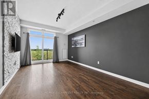 Burlington (Uptown) condo for rent - A spacious room with dark walls and a wooden floor.
