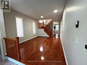 Brampton (Madoc) apartment for rent - A long hallway with wood floors and a staircase.