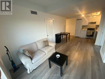 Toronto (Kensington-Chinatown) condo for rent - A living room with a white couch and a black coffee table.