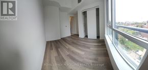Toronto (Kensington-Chinatown) condo for rent - A room with wooden flooring and a large window overlooking a cityscape.
