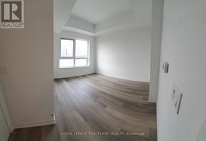 Toronto (Kensington-Chinatown) condo for rent - A room with wooden flooring and a window letting in light.