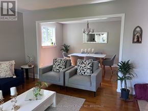 Kingston (North Of Taylor-Kidd Blvd) apartment for rent - A living room with a grey couch and a white coffee table.