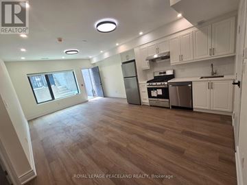 Toronto (University) apartment for rent - A kitchen with white cabinets and a wooden floor.