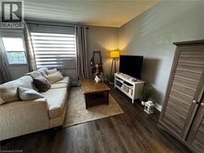 St. Catharines condo for rent - A living room with a couch, a coffee table, and a television.