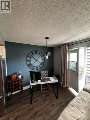 St. Catharines condo for rent - A living room with a couch, a chair, a table, and a clock on the wall.