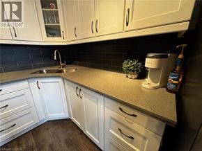 St. Catharines condo for rent - A kitchen with white cabinets and a sink.