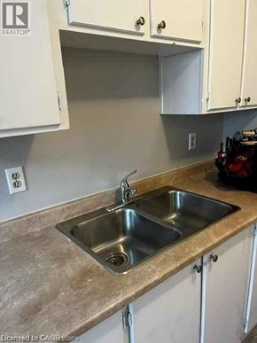 Waterloo condo for rent - A kitchen with a sink and cabinets.