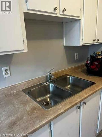 Waterloo condo for rent - A kitchen with a sink and cabinets.