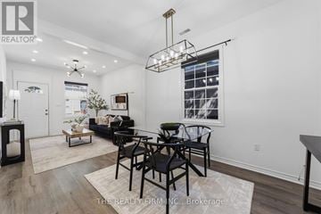 London East (East K) apartment for rent - A well-lit living room with a dining table and chairs.