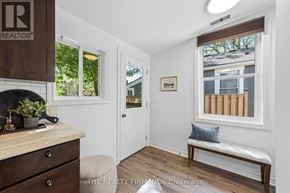 London East (East K) apartment for rent - A well-lit room with a window, a bench, and a table with a plant on it.