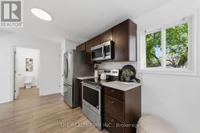 London East (East K) apartment for rent - A kitchen with wooden cabinets and appliances is shown.