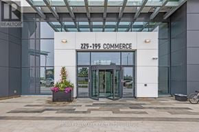 Vaughan (Vaughan Corporate Centre) condo for rent - The entrance to a building with a glass facade and a sign that reads "225-199 Commerce".