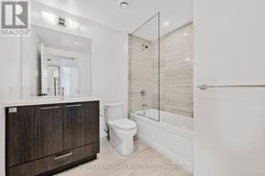 Vaughan (Vaughan Corporate Centre) condo for rent - A bathroom with a toilet, sink, and mirror.
