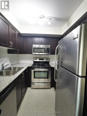 Toronto (Dovercourt-Wallace Emerson-Junction) condo for rent - A kitchen with a stove top oven and a refrigerator.