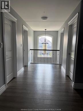 Belle River apartment for rent - A long hallway with a balcony and a chandelier.