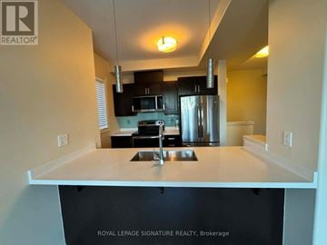 Hamilton (Stoney Creek Mountain) townhouse for rent - A kitchen with a sink and a refrigerator.