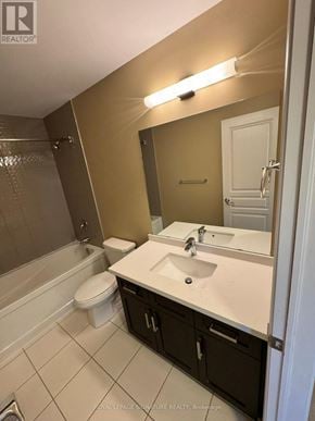 Hamilton (Stoney Creek Mountain) townhouse for rent - A bathroom with a toilet, sink, and mirror.