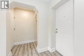 Ottawa multi-family for rent - A white door is on the right side of a hallway.