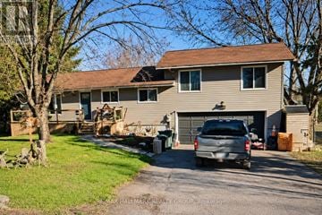 Ottawa apartment for rent - A house with a garage and a car parked in front.