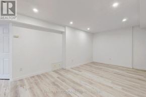 Barrie (Cundles East) apartment for rent - A room with white walls and wooden flooring with a door on the left.