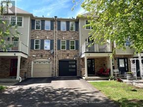 Milton (Co Coates) townhouse for rent - A large two story apartment building with a garage door and a balcony.