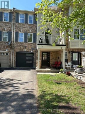 Milton (Co Coates) townhouse for rent - A building with a sign that says "REALTOR" on it.