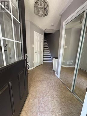 Milton (Co Coates) townhouse for rent - A hallway with a staircase and a chandelier.
