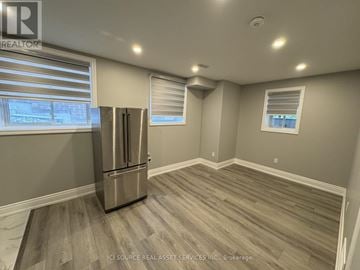Milton (Walker) apartment for rent - A kitchen with a stainless steel refrigerator and wooden flooring.