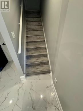 Milton (Walker) apartment for rent - A staircase with wooden steps and a marble floor.