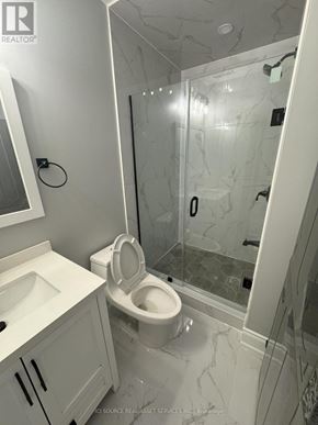 Milton (Walker) apartment for rent - A white bathroom with a toilet, sink, and shower.