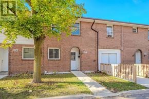 Guelph (Junction/Onward Willow) townhouse for rent - A brick house with a tree in front of it.