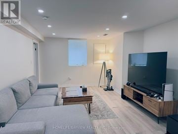 Newmarket (Bristol-London) apartment for rent - A modern living room with a grey sofa and a wooden coffee table.