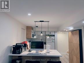 Newmarket (Bristol-London) apartment for rent - A modern home office with a desk, computer, and hanging lights.