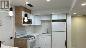 Newmarket (Bristol-London) apartment for rent - A modern kitchen with white appliances and wooden accents.